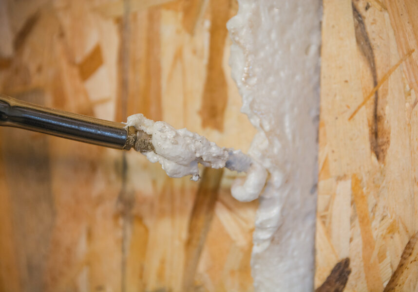 a person using a drill to fix a wall